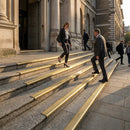 Brass 89mm bull nose stair nosings on the stone entrance steps of a public building