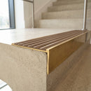 Solid brass 59mm slimline stair nosing with Antique Brass anti-slip insert fitted to a concrete step in a commercial stairwell