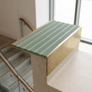 Solid brass 59mm slimline stair nosing with Jade Castellated anti-slip insert fitted to a concrete step in a commercial stairwell