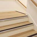 Brown PVC insert fitted in aluminium stair nosings on a hotel staircase