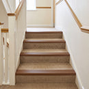 Brown self-adhesive PVC stair nosing 50mm x 42mm fitted full width on carpeted stairs in a UK home