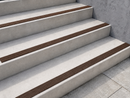 Brown dovetail inserts contrasting against pale concrete steps