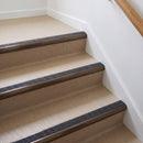 Bullnose aluminium stair nosing with a dark charcoal Mor Grip insert in dark bronze finish fitted on a flat or apartment communal stair finished in beige vinyl