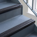 Bullnose aluminium stair nosing with twin dark charcoal Mor Grip inserts in satin black finish fitted on a hospital or clinic stair finished in blue-grey safety vinyl