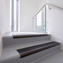 Bullnose DDA aluminium stair nosing 70 x 56mm in Dark Bronze with Coal Exterior Grip insert, fitted to grey vinyl stairs in an office stairwell