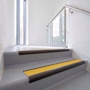 Bullnose DDA aluminium stair nosing 70 x 56mm in Dark Bronze with Solar High Grip insert, fitted to grey vinyl stairs in an office stairwell