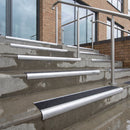 Bullnose DDA aluminium stair nosing 70 x 56mm in Mill Finish with Coal Exterior Grip insert, fitted to wet external concrete entrance steps