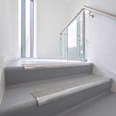 Bullnose DDA aluminium stair nosing 70 x 56mm in Mill Finish with Everest Exterior Grip insert, fitted to grey vinyl stairs in an office stairwell