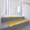 Bullnose DDA aluminium stair nosing 70 x 56mm in Mirrorflect Gold with Brimstone Exterior Grip insert, fitted to grey vinyl stairs in an office stairwell