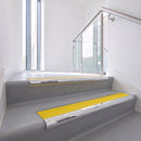 Bullnose DDA aluminium stair nosing 70 x 56mm in Mirrorflect Silver with Brimstone Exterior Grip insert, fitted to grey vinyl stairs in an office stairwell