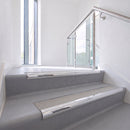 Bullnose DDA aluminium stair nosing 70 x 56mm in Mirrorflect Silver with Everest Exterior Grip insert, fitted to grey vinyl stairs in an office stairwell