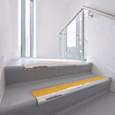 Bullnose DDA aluminium stair nosing 70 x 56mm in Mirrorflect Silver with Solar High Grip insert, fitted to grey vinyl stairs in an office stairwell