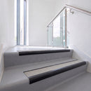 Bullnose DDA aluminium stair nosing 70 x 56mm in Satin Black with Everest Exterior Grip insert, fitted to grey vinyl stairs in an office stairwell