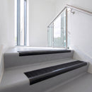Bullnose DDA aluminium stair nosing 70 x 56mm in Satin Black with Obsidian High Grip insert, fitted to grey vinyl stairs in an office stairwell