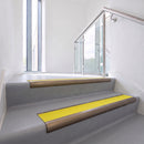 Bullnose DDA aluminium stair nosing 70 x 56mm in Satin Bronze with Brimstone Exterior Grip insert, fitted to grey vinyl stairs in an office stairwell