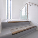 Bullnose DDA aluminium stair nosing 70 x 56mm in Satin Bronze with Everest Exterior Grip insert, fitted to grey vinyl stairs in an office stairwell