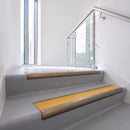 Bullnose DDA aluminium stair nosing 70 x 56mm in Satin Bronze with Solar High Grip insert, fitted to grey vinyl stairs in an office stairwell