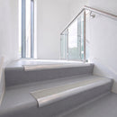 Bullnose DDA aluminium stair nosing 70 x 56mm in Satin Silver with Everest Exterior Grip insert, fitted to grey vinyl stairs in an office stairwell