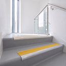 Bullnose DDA aluminium stair nosing 70 x 56mm in Satin Silver with Solar High Grip insert, fitted to grey vinyl stairs in an office stairwell