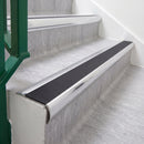 Bright Polished 70 x 37mm bullnose stair nosing, Obsidian High Grip insert, on vinyl school stairs