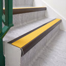 Dark Bronze 70 x 37mm bullnose stair nosing, Solar High Grip insert, on vinyl school stairs