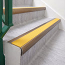 Satin Bronze 70 x 37mm bullnose stair nosing, Solar High Grip insert, on vinyl school stairs