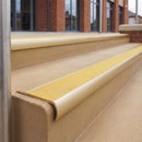 Satin Gold 70 x 37mm bullnose stair nosing, Brimstone Exterior Grip insert, on outdoor entrance steps