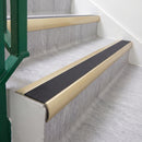 Satin Gold 70 x 37mm bullnose stair nosing, Obsidian High Grip insert, on vinyl school stairs