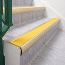 Satin Gold 70 x 37mm bullnose stair nosing, Solar High Grip insert, on vinyl school stairs
