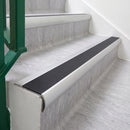Satin Silver 70 x 37mm bullnose stair nosing, Obsidian High Grip insert, on vinyl school stairs