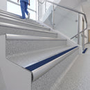 Bullnose stair nosing with blue anti-slip insert on commercial vinyl stairs in a healthcare building