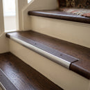 Bullnose stair nosing with brown anti-slip insert fitted to dark walnut timber stair treads