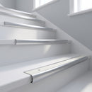 Bullnose stair nosing with white anti-slip insert fitted to white-painted timber stairs in a bright hallway