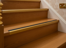 Gold anodised aluminium stair nosing 1200mm on traditional warm oak staircase