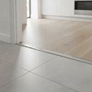 26mm T-bar floor transition strip installed at UK kitchen-to-hallway doorway between tiles and laminate