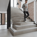 Heavy duty tile-in stair nosing in Canvas — real-life installation with person using tiled UK staircase