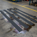 Extra coarse anti-slip tape on industrial factory floor with oil contamination risk