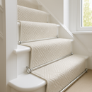 Chrome stair rods on cream geometric runner carpet — bright modern British hallway