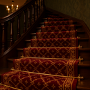Polished brass stair rods on burgundy and gold patterned runner carpet — grand British hallway