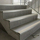 Slimline aluminium stair nosings with canvas cream anti-slip inserts on grey tiled stairs