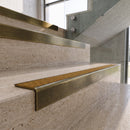 Antique Brass carborundum insert stair nosing with amber CarbiGrip insert fitted to travertine steps