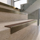 Antique Brass carborundum insert stair nosing with hazelnut CarbiGrip insert fitted to travertine steps