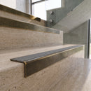 Antique Brass carborundum insert stair nosing with pebble CarbiGrip insert fitted to travertine steps