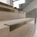 Antique Brass carborundum insert stair nosing with speckled pebble CarbiGrip insert fitted to travertine steps
