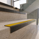 Antique Bronze carborundum insert stair nosing with canary yellow ridged PVC insert fitted to travertine steps