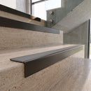 Antique Bronze carborundum insert stair nosing with fog grey ridged PVC insert fitted to travertine steps