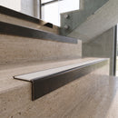 Antique Bronze carborundum insert stair nosing with snow white ridged PVC insert fitted to travertine steps