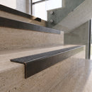 Antique Bronze carborundum insert stair nosing with speckled graphite CarbiGrip insert fitted to travertine steps