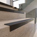 Antique Bronze carborundum insert stair nosing with storm grey ridged PVC insert fitted to travertine steps
