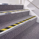 Bright Polished double insert chevron stair nosing, 40mm riser with Hazard black and yellow inserts, fitted on carpeted stairs